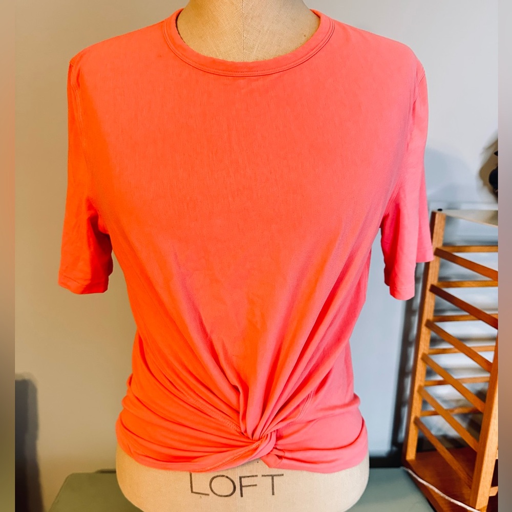 Lululemon Crescent Tee. It is a short-sleeve athletic t-shirt twisted hem size 4